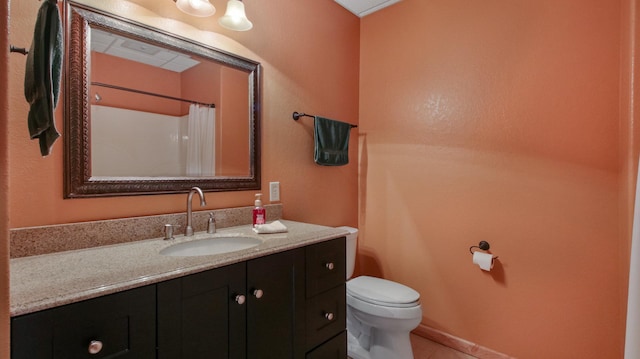 bathroom with tile patterned flooring, vanity, and toilet