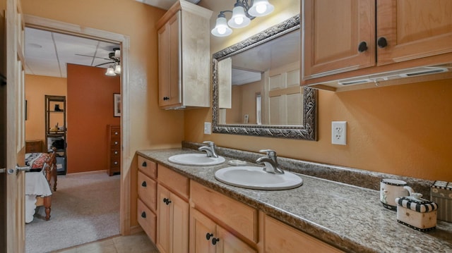 ensuite bathroom with double vanity, tile patterned flooring, a sink, and ensuite bathroom