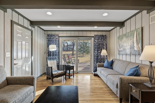 living room featuring recessed lighting, beamed ceiling, and light wood-style floors