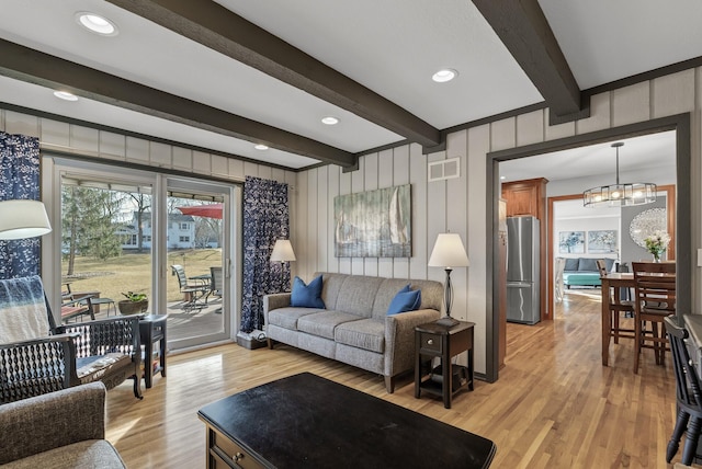 living room featuring visible vents, a chandelier, beam ceiling, recessed lighting, and light wood-style floors