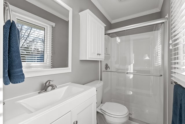 bathroom with vanity, crown molding, toilet, and a stall shower