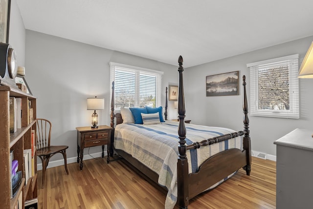 bedroom with visible vents, baseboards, and light wood-type flooring