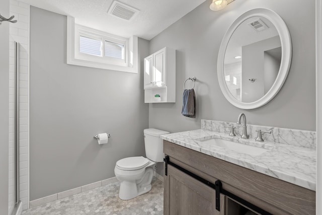 bathroom with visible vents, tiled shower, toilet, and baseboards