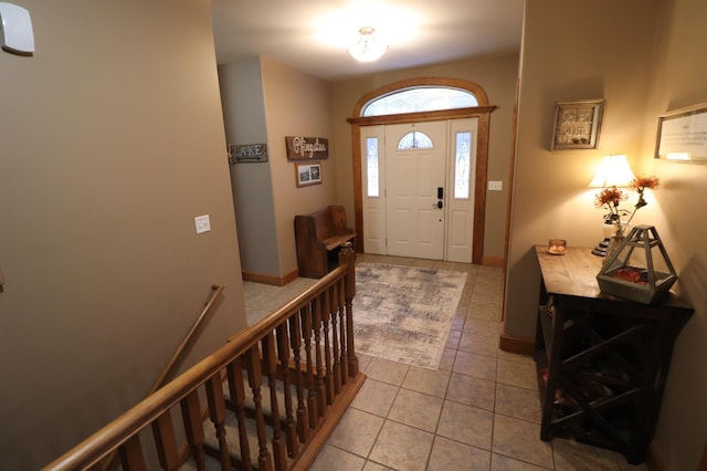 foyer with baseboards and tile patterned floors