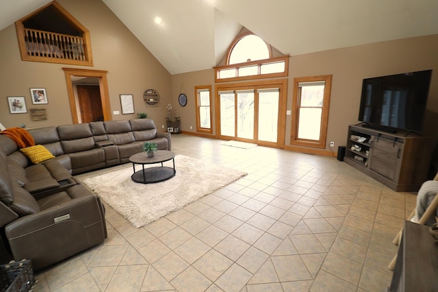 living area featuring high vaulted ceiling and light tile patterned floors