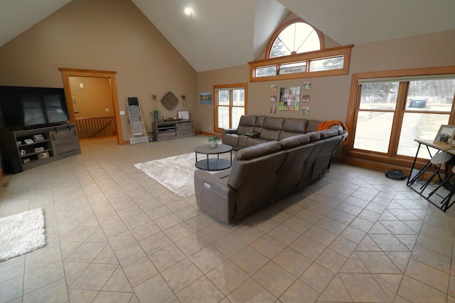 living room featuring high vaulted ceiling and light tile patterned flooring