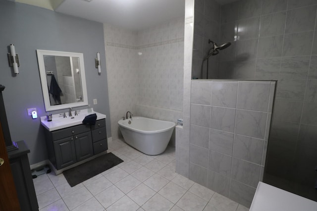 bathroom featuring a walk in shower, a freestanding bath, vanity, and tile patterned floors