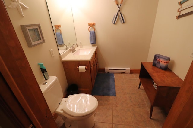 bathroom with vanity, baseboard heating, tile patterned flooring, and toilet