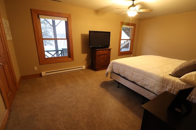 carpeted bedroom featuring a baseboard radiator, visible vents, ceiling fan, and baseboards