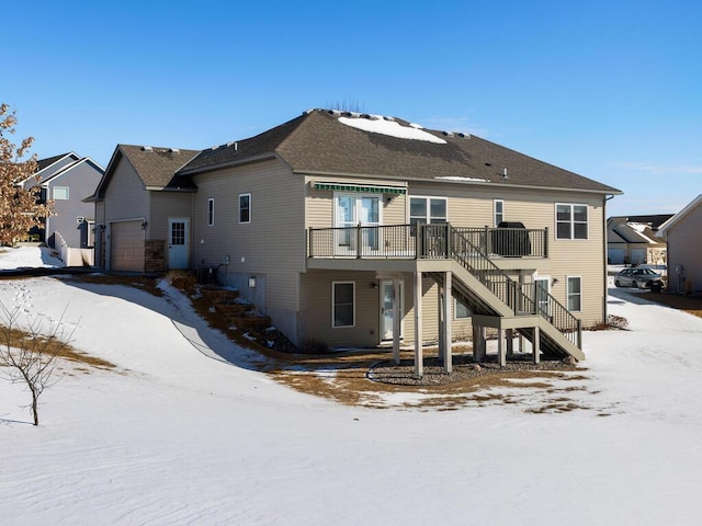 snow covered house with stairs and central AC