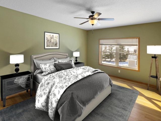 bedroom with ceiling fan, a textured ceiling, and wood finished floors