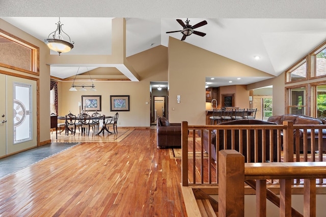 entryway with lofted ceiling, baseboards, and hardwood / wood-style flooring