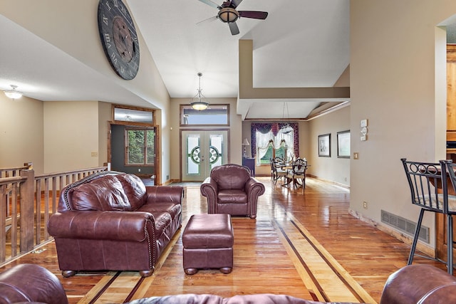 living room with baseboards, visible vents, ceiling fan, wood finished floors, and french doors