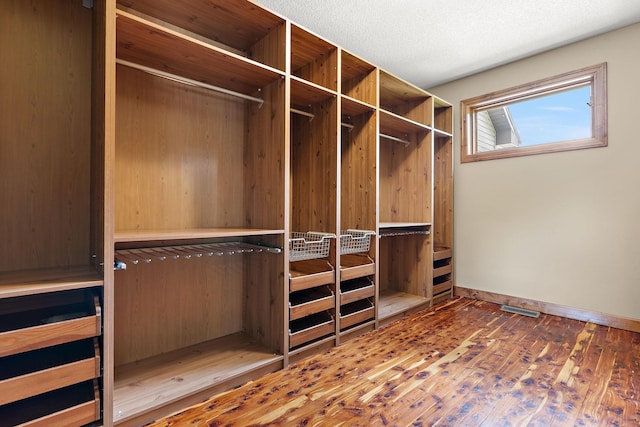 spacious closet with wood finished floors