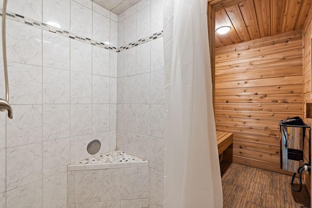 full bath featuring wood ceiling, tiled shower, a sauna, and wood finished floors