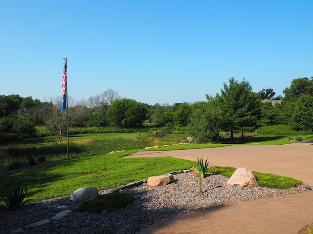 view of property's community featuring a yard