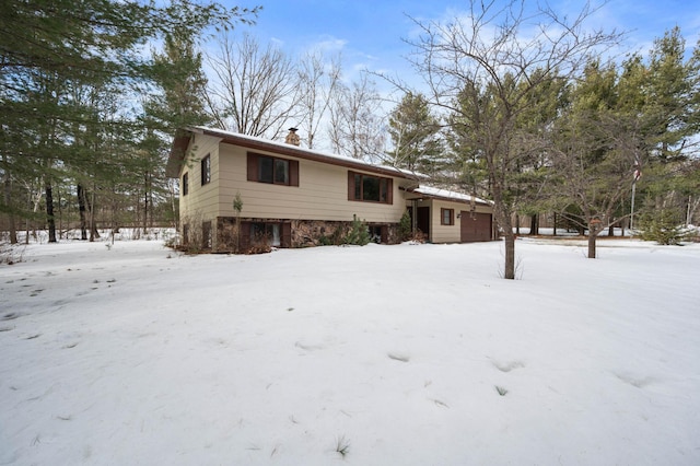 view of front of home featuring a chimney and an attached garage