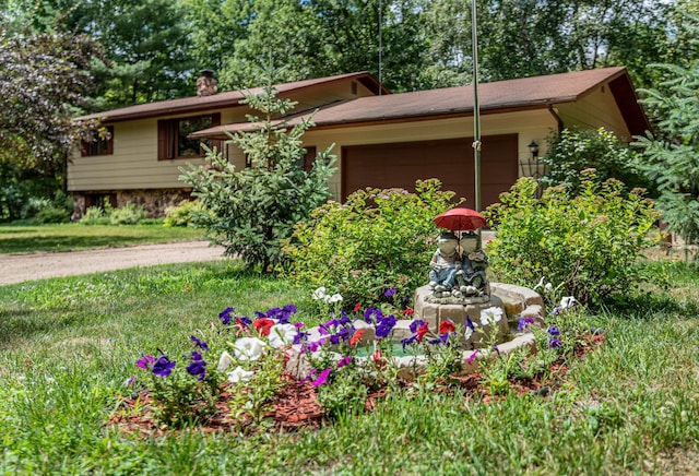 view of front of house featuring a garage and a chimney