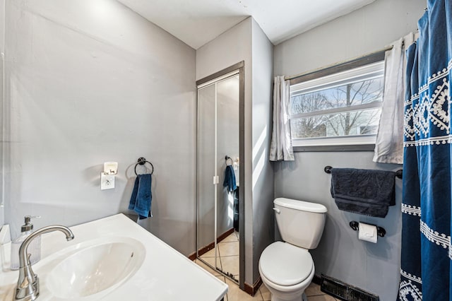 full bath featuring vanity, toilet, a shower stall, and tile patterned flooring