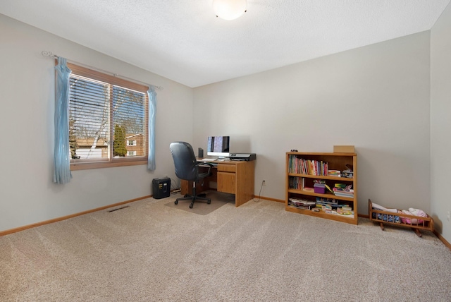 office area featuring light carpet, visible vents, a textured ceiling, and baseboards