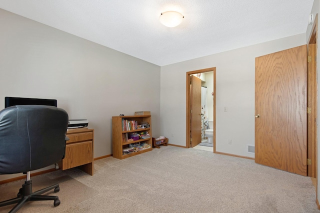 home office with visible vents, light colored carpet, and baseboards