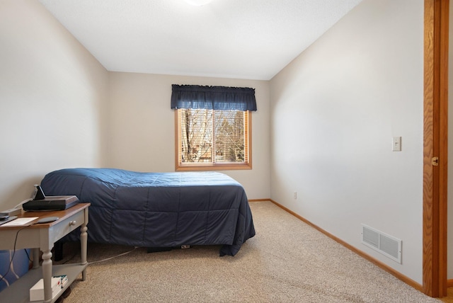 bedroom featuring visible vents, baseboards, light colored carpet, and lofted ceiling