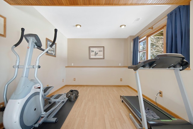 workout area featuring baseboards and wood finished floors