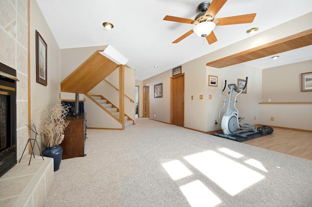 workout area with carpet, baseboards, a ceiling fan, recessed lighting, and a glass covered fireplace