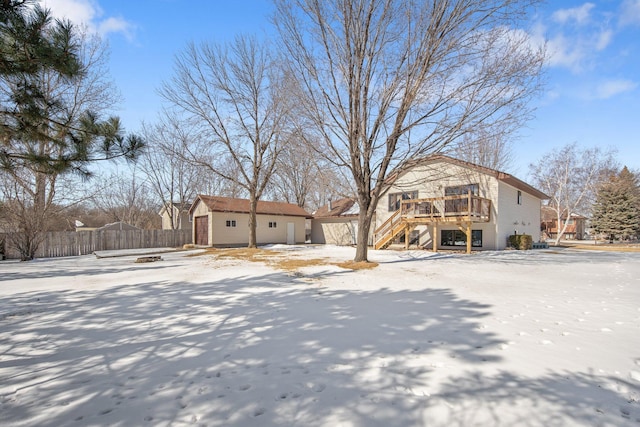 view of front of house with an outbuilding, stairway, fence, a wooden deck, and a storage unit