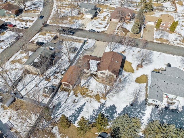 snowy aerial view featuring a residential view