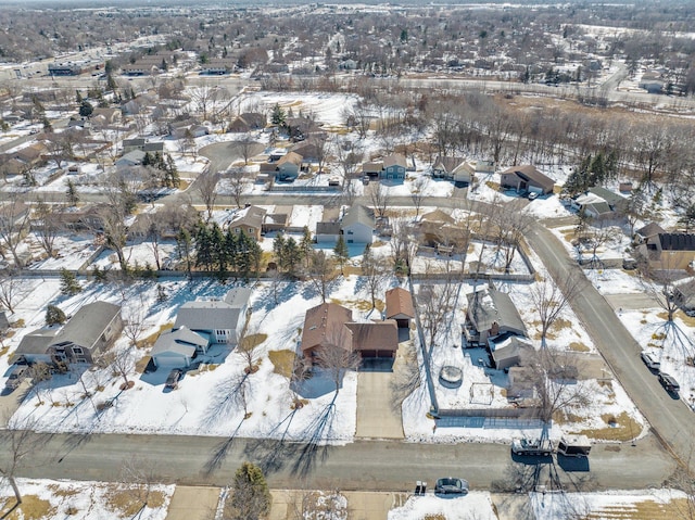 snowy aerial view featuring a residential view