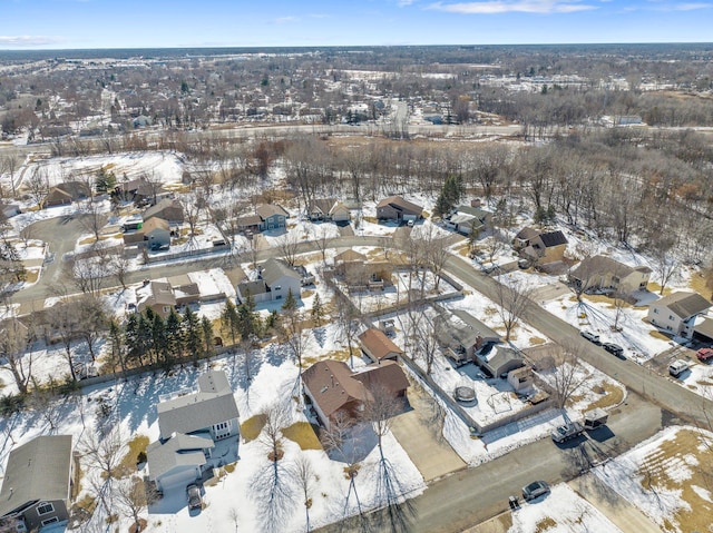 snowy aerial view with a residential view