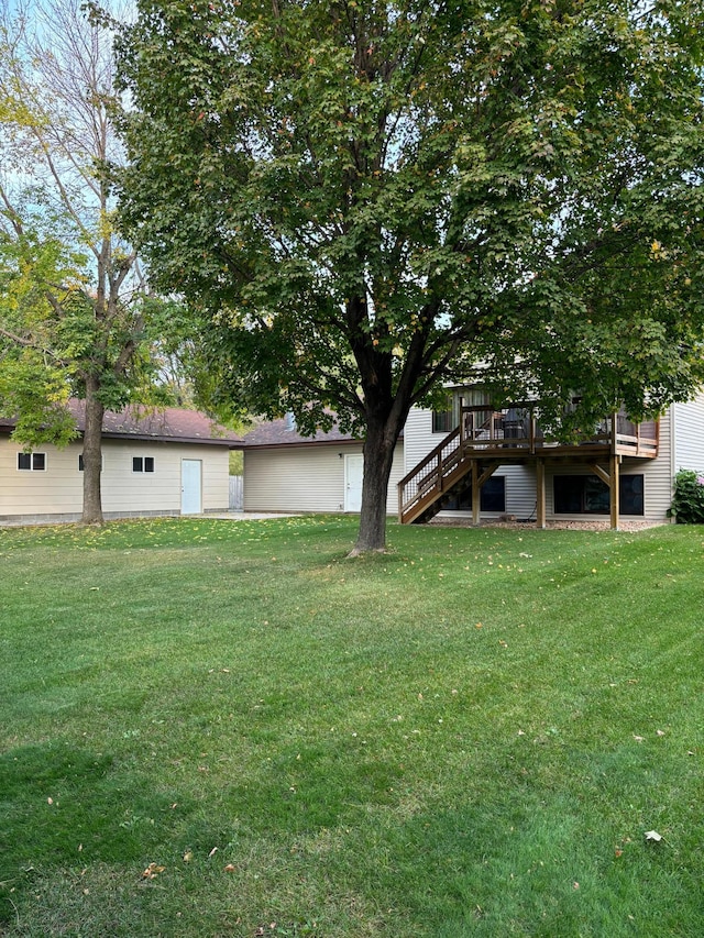 view of yard with a deck and stairs