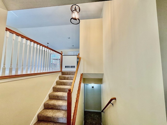 staircase featuring visible vents, baseboards, and carpet floors