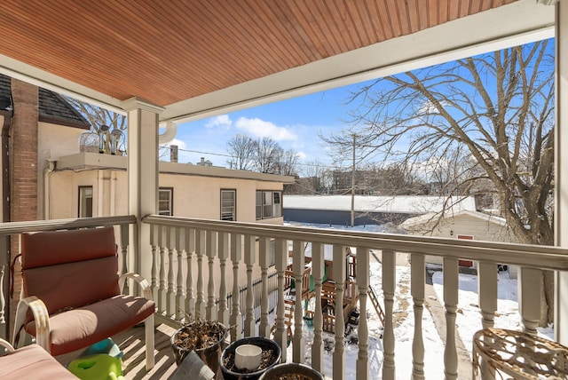 view of snow covered back of property