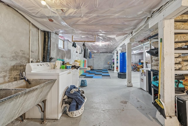 below grade area with water heater, washer and dryer, and a sink