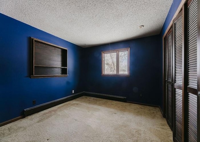 unfurnished bedroom featuring carpet, a textured ceiling, baseboards, and a closet