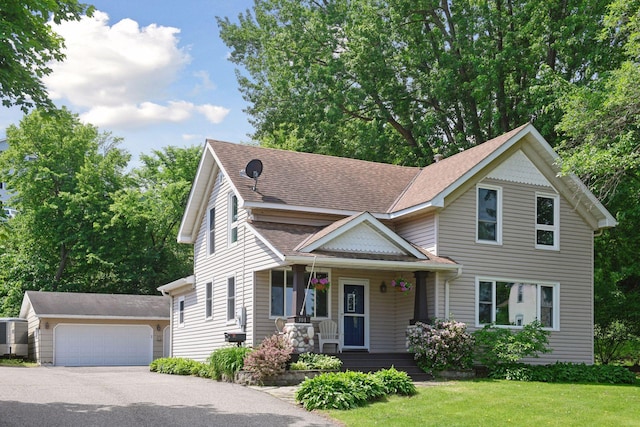 301 Lake St, Waconia, MN 55387 - victorian house with a porch, an outdoor structure, a front yard, a shingled roof, and a detached garage