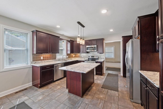 301 Lake St, Waconia, MN 55387 - kitchen with appliances with stainless steel finishes, backsplash, healthy amount of natural light, and recessed lighting