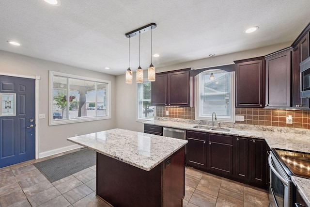 301 Lake St, Waconia, MN 55387 - kitchen with a sink, appliances with stainless steel finishes, backsplash, a center island, and recessed lighting
