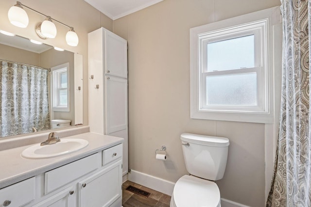 301 Lake St, Waconia, MN 55387 - full bathroom with toilet, vanity, baseboards, and crown molding