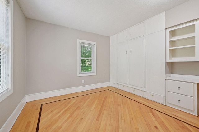 301 Lake St, Waconia, MN 55387 - unfurnished bedroom featuring hardwood / wood-style flooring and baseboards
