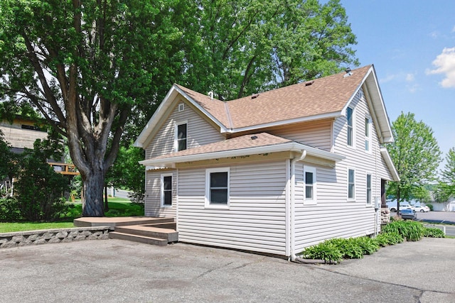 301 Lake St, Waconia, MN 55387 - view of home's exterior featuring roof with shingles and a patio area