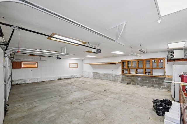 301 Lake St, Waconia, MN 55387 - garage with a garage door opener and freestanding refrigerator
