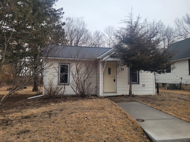 view of front of home with central AC and roof with shingles