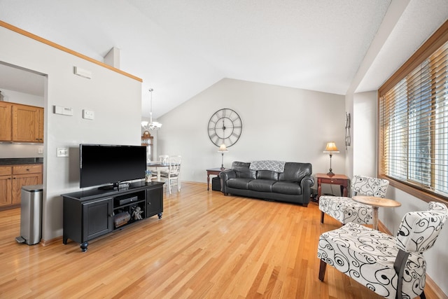 living room with light wood-style floors, lofted ceiling, baseboards, and an inviting chandelier