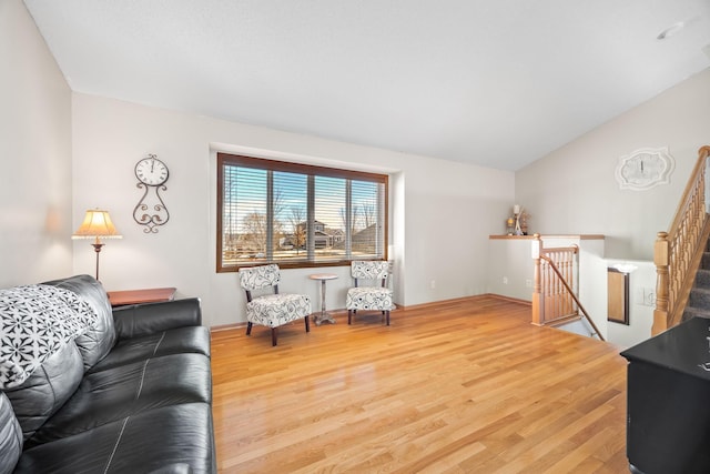 living room featuring vaulted ceiling and light wood-type flooring