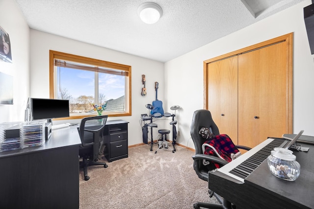 home office with a textured ceiling, carpet, and baseboards