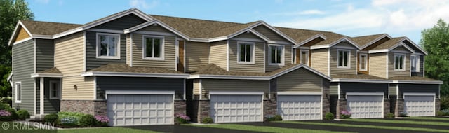 view of front of home with a garage, stone siding, and driveway