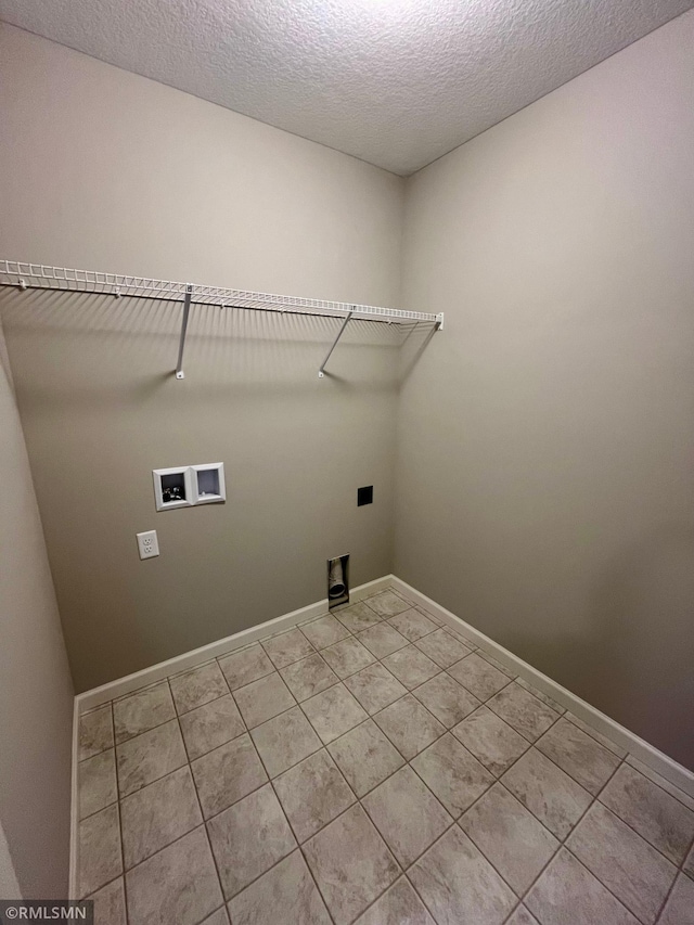 washroom featuring laundry area, baseboards, a textured ceiling, hookup for an electric dryer, and washer hookup